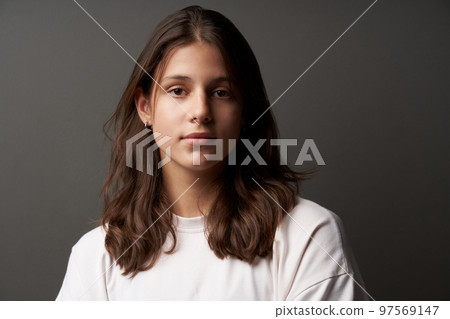 Closeup portrait of casual natural girl looking calm and confident Closeup portrait of casual natural girl looking calm and confident 97569147