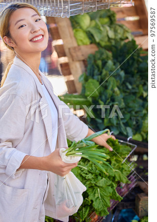 Grocery store, vegetable shopping and customer asian woman with product price and happy with discount, sale or promotion discount. Groceries, supermarket female with green retail food choice offer Grocery store, vegetable shopping and customer asian woman with product price and happy with discount, sale or promotion discount. Groceries, supermarket female with green retail food choice offer 97569587