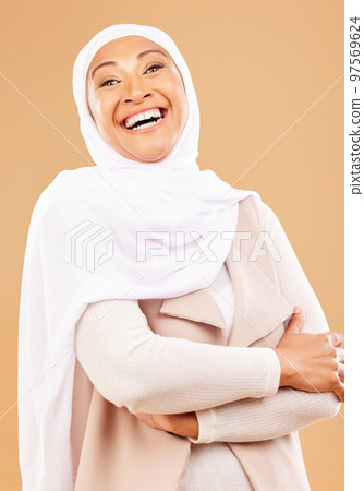 Laughing muslim woman, arms crossed or fashion hijab on studio background is religion empowerment, traditional pride or Iranian rights success. Portrait, smile or mature Islamic model in trendy scarf 97569624