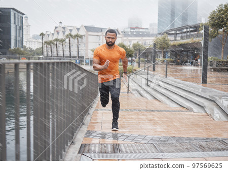 City fitness, man and running in rain for exercise, body workout and cardio training. Portrait, wet and urban runner with focus, motivation and strong motivation for sports, power and marathon energy City fitness, man and running in rain for exercise, body workout and cardio training. Portrait, wet and urban runner with focus, motivation and strong motivation for sports, power and marathon energy 97569625