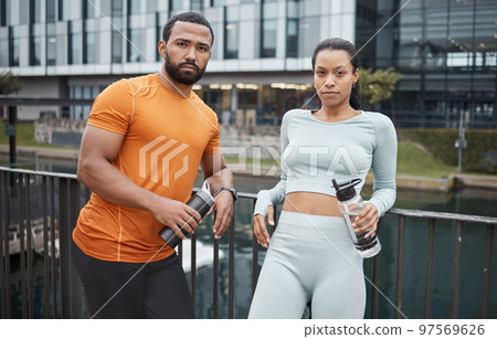 Portrait, fitness or black couple in city for workout, relax after workout or with water bottle for drinking. Partner, wellness or black woman and man for sports, training or running break in Canada 97569626