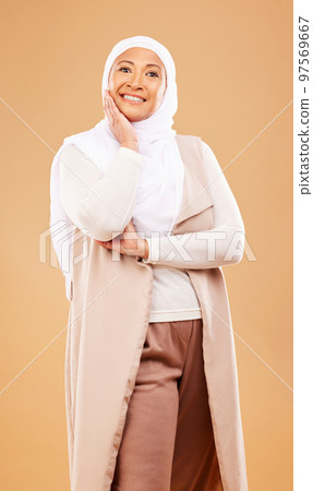 Fashion, beauty and portrait of muslim woman in studio isolated on an orange background. Skincare, cosmetics and mature Islamic female from Dubai in makeup posing in stylish hijab and modern clothes. Fashion, beauty and portrait of muslim woman in studio isolated on an orange background. Skincare, cosmetics and mature Islamic female from Dubai in makeup posing in stylish hijab and modern clothes. 97569667