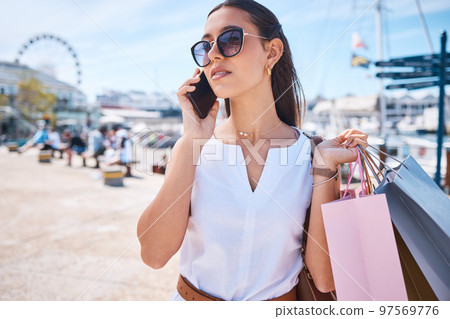 Shopping, fashion and woman on a phone call in city with shopping bags in Miami for sale, discount and bargain. Communication, retail and female with smartphone, sunglasses and trendy style in street Shopping, fashion and woman on a phone call in city with shopping bags in Miami for sale, discount and bargain. Communication, retail and female with smartphone, sunglasses and trendy style in street 97569776