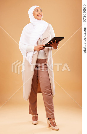 Fashion, muslim and woman with tablet in studio isolated on a brown background mock up. Technology, touchscreen and mature Islamic female thinking of internet browsing, social media or web scrolling. Fashion, muslim and woman with tablet in studio isolated on a brown background mock up. Technology, touchscreen and mature Islamic female thinking of internet browsing, social media or web scrolling. 97569869