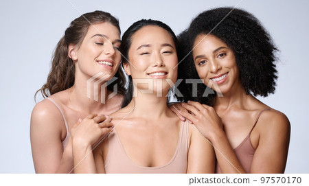 Women, faces diversity or skincare glow on studio background in healthcare wellness, self love empowerment or community support. Portrait, smile or happy beauty models or friends and makeup cosmetics 97570170
