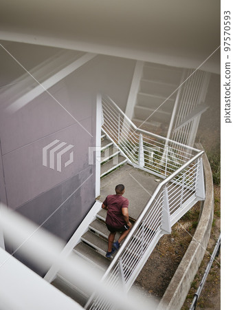 Running, fitness and top view of black man on stairs for health, wellness and exercise. Sports, training and male runner jog, exercising or cardio workout on steps outdoors for strength and endurance 97570593