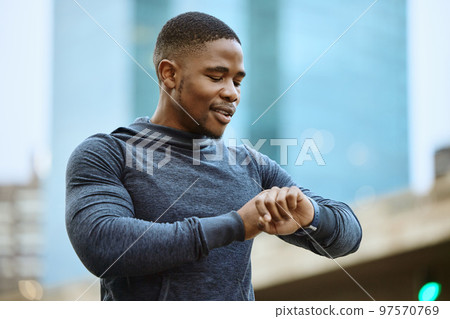 Fitness, black man and checking time in the city ready for exercise, workout or cardio training in the outdoors. Active man in sports looking at smart watch for heart monitoring, rate or performance Fitness, black man and checking time in the city ready for exercise, workout or cardio training in the outdoors. Active man in sports looking at smart watch for heart monitoring, rate or performance 97570769
