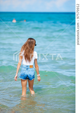 Adorable teen girl on the beach enjoy her summer vacation Adorable teen girl on the beach enjoy her summer vacation 97570912