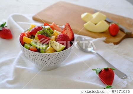 Bowl of healthy fresh fruit salad on white napkin 97571026