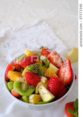 Bowl of healthy fresh fruit salad on white napkin 97571340