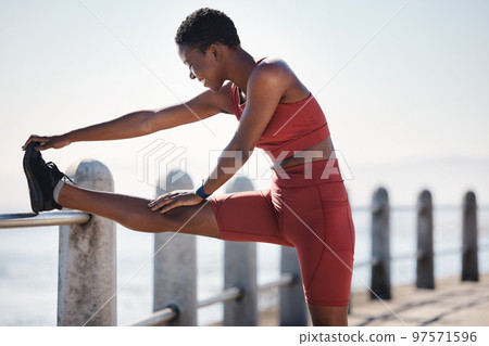 Stretching, running and fitness with black woman at beach for workout, freedom and jogging. Summer, energy and peace with girl runner and warm up at sea promenade for cardio, endurance and training Stretching, running and fitness with black woman at beach for workout, freedom and jogging. Summer, energy and peace with girl runner and warm up at sea promenade for cardio, endurance and training 97571596