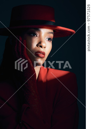 Dark, spotlight and sexy with fashion and woman with face and seduction with red aesthetic against studio background. Sensual, beauty and skin with makeup and mystery, vintage or retro style. 97571826