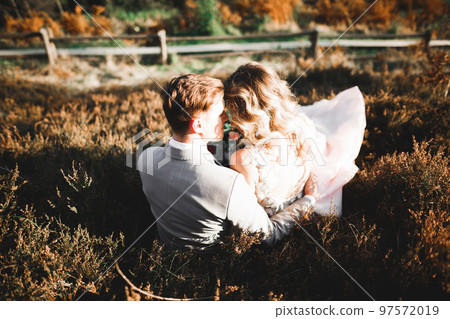Gorgeous happy couple standing close to each other and looking in eyes 97572019