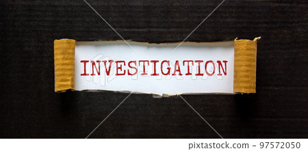 The word 'investigation' appearing behind torn black paper. Business concept. 97572050