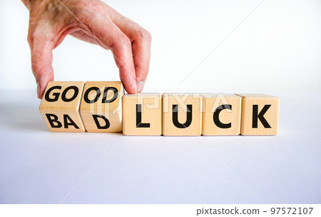 Good or bad luck symbol. Businessman turns wooden cubes and changes words 'bad luck' to 'good luck'. Beautiful white background, copy space. Business and good or bad luck concept. 97572107