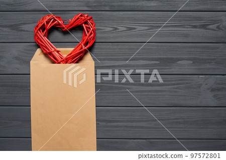 Blank envelope on wooden plank table with heart shape Blank envelope on wooden plank table with heart shape 97572801