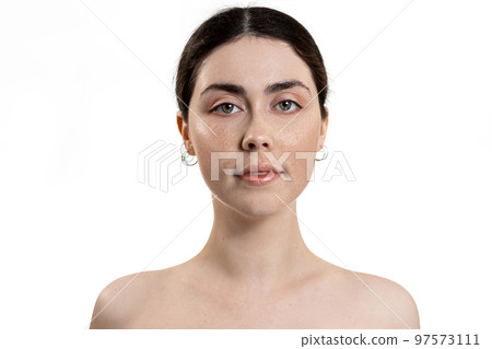 Beauty and skin care. Portrait of a young beautiful Caucasian woman. White background. The concept of cosmetology and skin rejuvenation 97573111