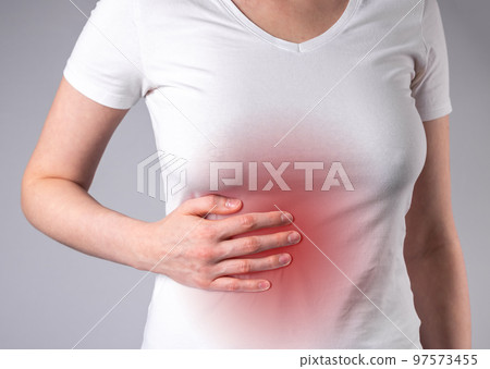 Woman suffering from liver pain. Hand holding abdomen with red point closeup. Stomach ache. Inflammation, liver cirrhosis. Healthy lifestyle concept Woman suffering from liver pain. Hand holding abdomen with red point closeup. Stomach ache. Inflammation, liver cirrhosis. Healthy lifestyle concept 97573455