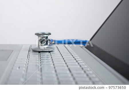 Stethoscope on laptop. Telemedicine, telehealth concept. Remote treatment of patients. Stethoscope on laptop. Telemedicine, telehealth concept. Remote treatment of patients. 97573650
