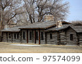 Log cabins displayed outdoors. 97574099
