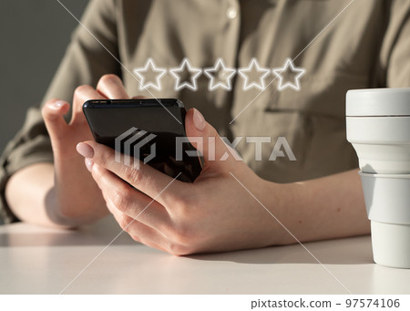 Woman using phone for rating of service, smartphone application or product quality. Online customer satisfaction feedback. Woman using phone for rating of service, smartphone application or product quality. Online customer satisfaction feedback. 97574106