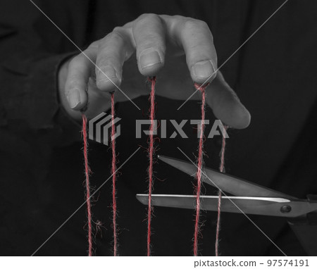 Overcoming addiction, getting rid of abuse and influence concept. Scissors cutting strings on man fingers. Mental health concerns or control and manipulation stop. Overcoming addiction, getting rid of abuse and influence concept. Scissors cutting strings on man fingers. Mental health concerns or control and manipulation stop. 97574191
