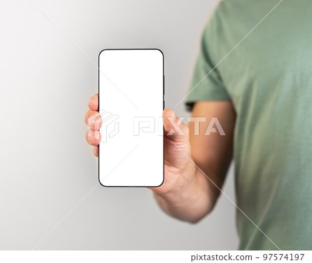 Man holding phone mockup in vertical position. Person using smartphone for showing photo or information. empty screen Man holding phone mockup in vertical position. Person using smartphone for showing photo or information. empty screen 97574197