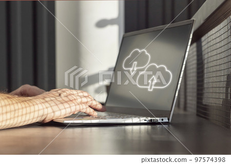 Cloud computing. Man using laptop for upload, storage, download or sharing files and data online. Male hands on computer keyboard closeup Cloud computing. Man using laptop for upload, storage, download or sharing files and data online. Male hands on computer keyboard closeup 97574398