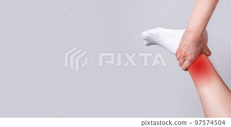 Banner with ankle pain with red spot. Foot injuries. Sport, household traumas to bones, ligaments or tendons. Arthritis. Health care and medicine concept. Place for text Banner with ankle pain with red spot. Foot injuries. Sport, household traumas to bones, ligaments or tendons. Arthritis. Health care and medicine concept. Place for text 97574504