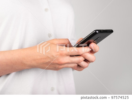Woman hands texting message at phone. Female using messenger at Android for chatting or surfing Internet. Modern lifestyle with telephone concept. Profile view 97574525