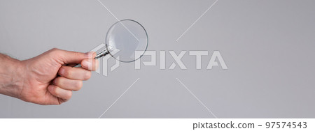 Banner with man hand with magnifying glass. Data search analysis, conducting research, nuances, important details study, preparation for exams concept. Space for text Banner with man hand with magnifying glass. Data search analysis, conducting research, nuances, important details study, preparation for exams concept. Space for text 97574543