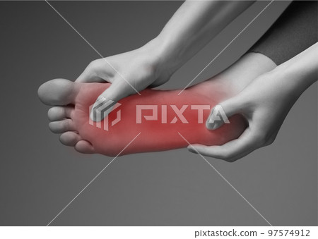 Foot pain. Woman hands holding leg with red point. Black and white. Inflammation, injury, chronic diseases consequences. Health problems concept. Foot pain. Woman hands holding leg with red point. Black and white. Inflammation, injury, chronic diseases consequences. Health problems concept. 97574912