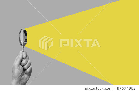 Man hand with magnifying glass. Yellow ray coming from loupe. Conducting check, information search and analysis concept. Spy, accountant, auditor job in abstract style. 97574992