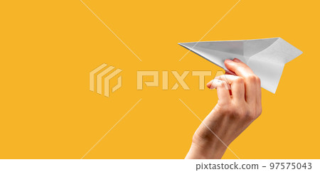 Banner with woman hand throwing origami plane on orange background. Freedom, start concept. Paper folding art. Place for text 97575043