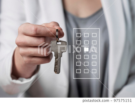 Woman hand with apartment keys closeup. Real estate purchase or house rent. Moving into new home concept. 97575151