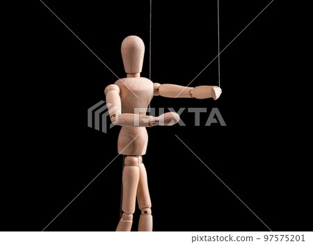 Puppet on strings. Manipulation, control, power, abuse concept. Marionette in human hand. Puppet on strings. Manipulation, control, power, abuse concept. Marionette in human hand. 97575201
