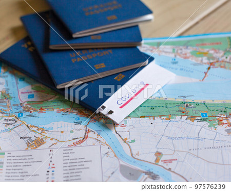 Passport and note with Covid-19 inscription. 97576239