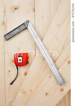 A measuring tape and a square. 97576244