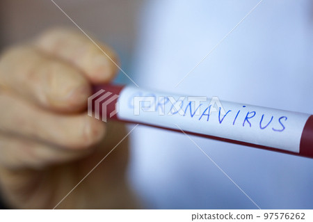 Hand holding blood test result for Coronavirus Hand holding blood test result for Coronavirus 97576262