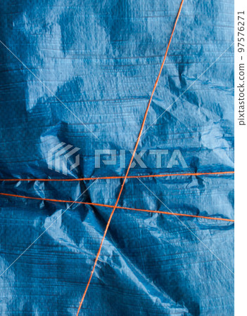 Blue crumpled synthetic fabric. 97576271