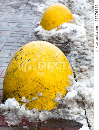 Concrete parking bollards on the road. Concrete parking bollards on the road. 97576451