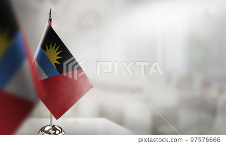 Small flags of the Antigua and Barbuda on an abstract blurry background Small flags of the Antigua and Barbuda on an abstract blurry background 97576666