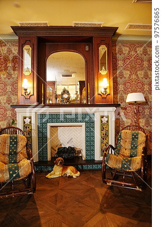 rocking chairs by the fireplace. interior in retro style. rocking chairs by the fireplace. interior in retro style. 97576865