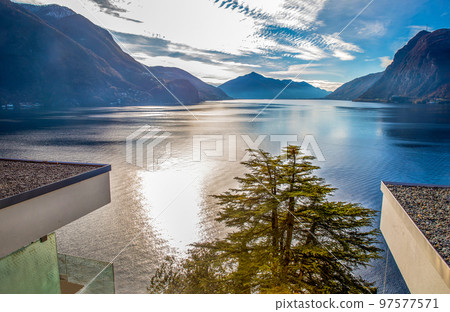 Sunny View  on lake Lugano and good residential buildings on shore  with fantastic cedar tree 97577571