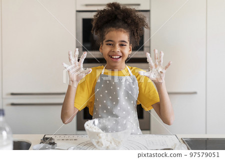 Black Girl Showing Sticky Hands Full Of Dough While Baking In Kitchen 97579051