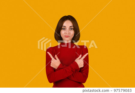 Confused pretty brunette lady pointing at copy space Confused pretty brunette lady pointing at copy space 97579083