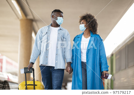 Pandemic Travels. African American Couple Wearing Medical Masks Walking At Railway Station 97579217