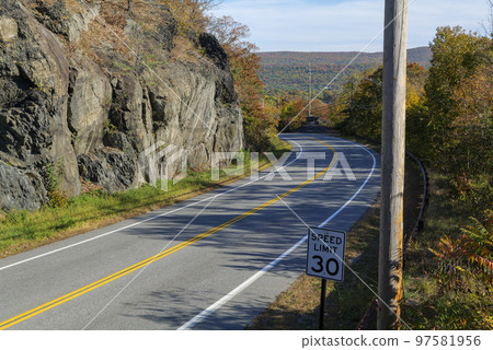 mountain road on a sunny day, blue sky in a background mountain road on a sunny day, blue sky in a background 97581956