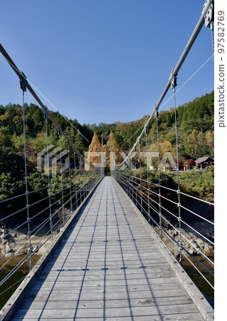 Suspension bridge of Nunobe Dam in Shimane prefecture in sunny autumn Suspension bridge of Nunobe Dam in Shimane prefecture in sunny autumn 97582769