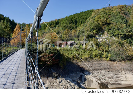 Suspension bridge of Nunobe Dam in Shimane prefecture in sunny autumn Suspension bridge of Nunobe Dam in Shimane prefecture in sunny autumn 97582770